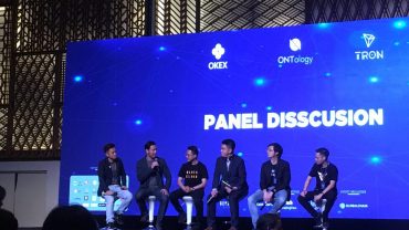 Photo of Thuc Vu on stage at OKEX event.