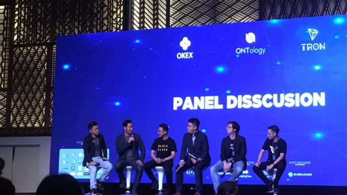 Photo of Thuc Vu on stage at OKEX blockchain event.