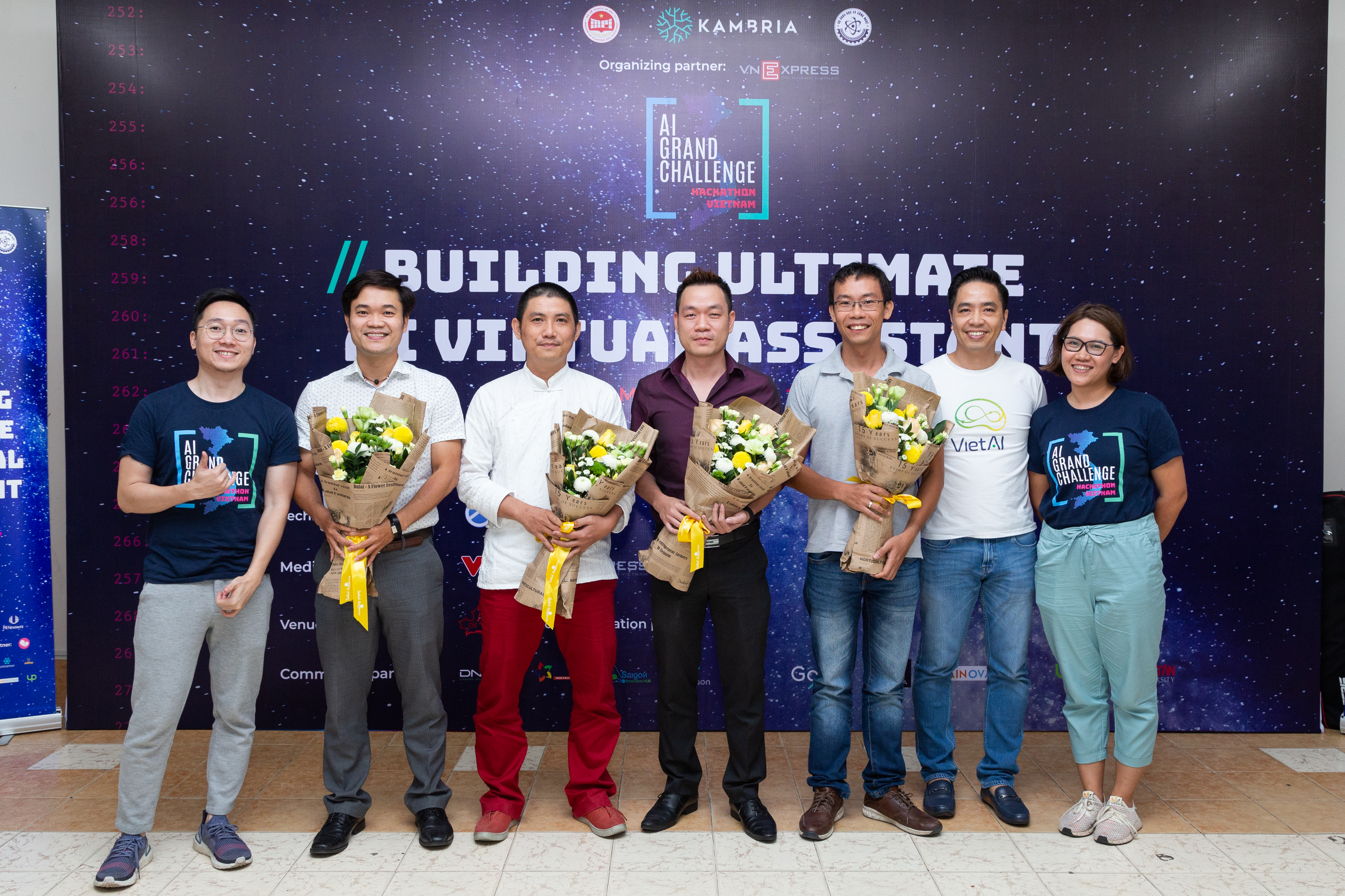 Vietnam AI Grand Challenge Hackathon Judges on stage holding flowers